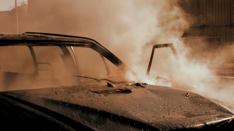 A car in smoke following a traffic accident